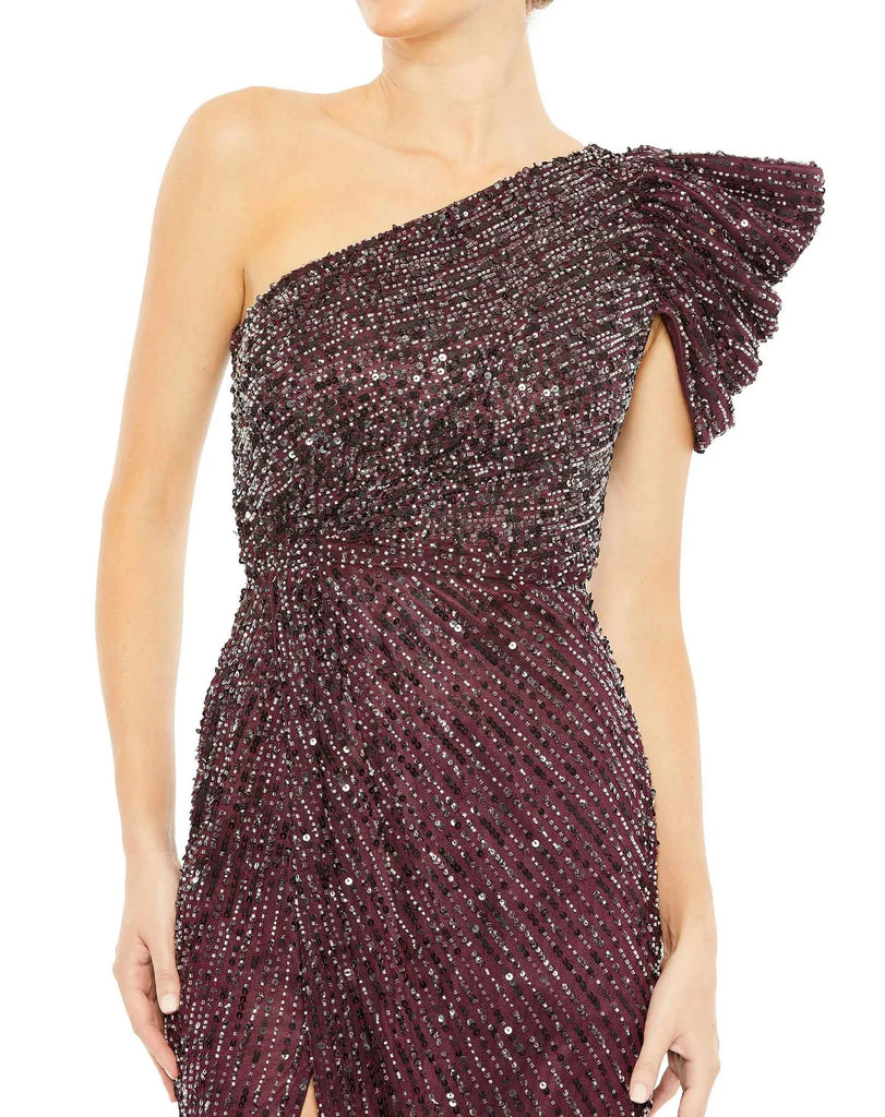 This beautiful dark purple coloured sequin, one-shoulder, asymmetric floor-length, evening gown with a beautiful cinched waist and puff detail on the shoulder is an elegant gown for special occasions and events with one thigh high split and an elegant form-fitting fit close up