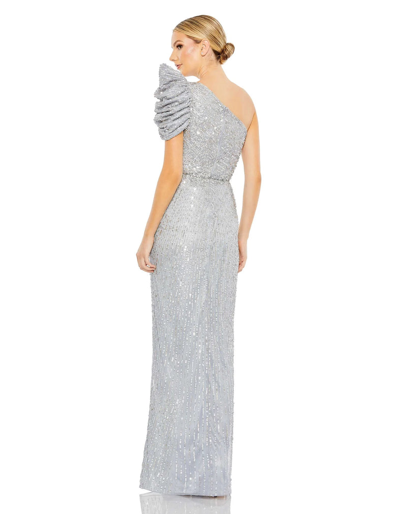 vThis beautiful silver sequin, one-shoulder, asymmetric floor-length, evening gown with a beautiful cinched waist and puff detail on the shoulder is an elegant gown for special occasions and events with one thigh high split and an elegant form-fitting fit back view