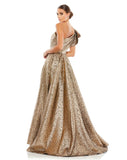 This stunningly elegant, one-shoulder metallic brocade antique gold, ball gown is a truly show-stopping evening dress accented with asymmetric chest detail, bow-detail on the shoulder, a cinched in waist and a beautiful full skirt with a thigh high split. This A line ball gown is perfect for proms, black-tie affairs, weddings and special events back view