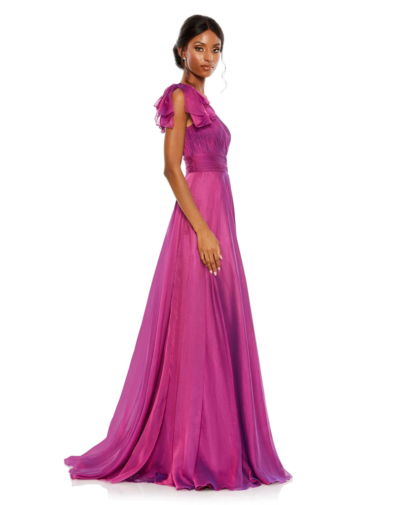 This elegant Mac Duggal one-sleeved raspberry, dress is a stunning formal gown for special occasions. With beautiful draped asymmetric detail across one shoulder and an empire bust together with a flower skirt, this elegant gown will truly have you feeling like the belle of the ball. side view