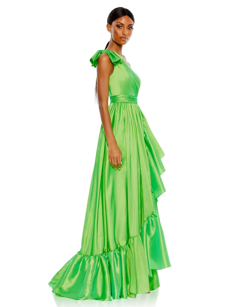 This elegant Mac Duggal floor-length, iridescent spring green taffeta evening gown is styled with a bow-topped shoulder, a cascading oversized ruffle, and a high-low hem. Pleats and gathers add pretty texture to enhance the look. This sophisticated asymmetric shoulder gown is perfect for proms, black-tie affairs, weddings, brides and special events side view