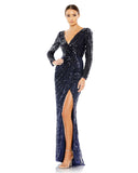 This stunning Mac Duggal elegant long-sleeved, midnight, evening gown is a beautiful, full-length evening dress with faux-wrap detail and all over sequins. With one sexy-thigh high split, dress is perfect for proms, weddings and special events! front