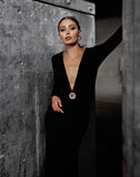 This elegant Mac Duggal long, black, long-sleeve jersey gown with a plunging v-neckline, gathered waist, and jewelled keyhole midriff is the perfect dress perfect for proms, black-tie affairs, weddings and special events!